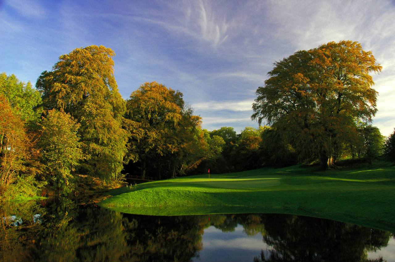 A green beside the water at New Forest Golf Club